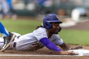 LSU Tiger outfielder Chris Stanfield (1) slides to third base against the UCLA Bruins during the College World Series on Tuesday, June 17, 2025 in Omaha, Nebraska. Photo by John S. Peterson.