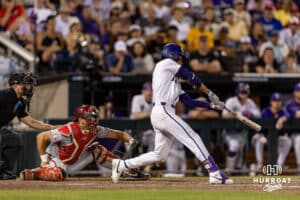 LSU Tiger outfielder Derek Curiel (6) doubles against the Arkansas Razorbacks in the ninth inning during the College World Series on Wednesday, June 18, 2025 in Omaha, Nebraska. Photo by John S. Peterson.