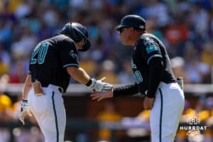 Coastal Carolina Chanticleer Wells Sykes (20) gives coach five rounding third after hitting a home run against the LSU Tigers in the seventh inning in the second game of the finals during the College World Series on Sunday, June 22, 2025 in Omaha, Nebraska. Photo by John S. Peterson.