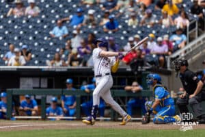LSU Tiger first baseman Jared Jones (22) hits a one-run single in the eighth inning against the UCLA Bruins during the College World Series on Tuesday, June 17, 2025 in Omaha, Nebraska. Photo by John S. Peterson.