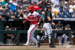 Louisville Cardinal infielder Jake Munroe (20) scores a run against the Coastal Carolina Chanticleers in the sixth inning during the College World Series on Wednesday, June 18, 2025 in Omaha, Nebraska. Photo by John S. Peterson.