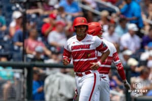 Louisville Cardinal Jake Munroe (20) heads to the dugout after scoring a run in the sixth inning against the Coastal Carolina Chanticleers during the College World Series on Wednesday, June 18, 2025 in Omaha, Nebraska. Photo by John S. Peterson.