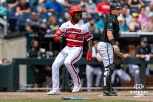 Louisville Cardinal Eddie King Jr. (42) scores a run against the Coastal Carolina Chanticleers in the sixth inning during the College World Series on Wednesday, June 18, 2025 in Omaha, Nebraska. Photo by John S. Peterson.