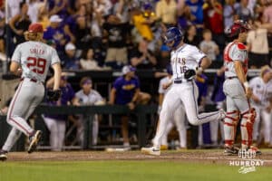 LSU Tiger outfielder Ethan Frey (16) scores in the ninth inning against against the Arkansas Razorbacks during the College World Series on Wednesday, June 18, 2025 in Omaha, Nebraska. Photo by John S. Peterson.
