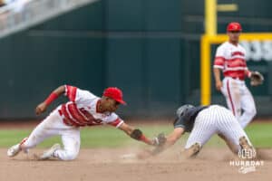 Coastal Carolina Chanticleer Blake Barthol (7) steals second against Louisville Cardinal infielder Kamau Neighbors (5) in the sixth inning during the College World Series on Wednesday, June 18, 2025 in Omaha, Nebraska. Photo by John S. Peterson.