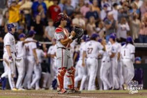 Arkansas Razorback catcher Ryder Helfrick (27) pounds his glove after LSU Tigers score two runs in the ninth during the College World Series on Wednesday, June 18, 2025 in Omaha, Nebraska. Photo by John S. Peterson.