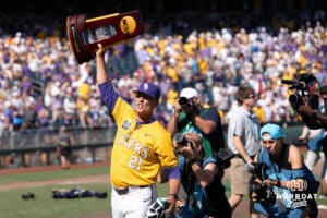 LSU Tigers assistant coach Josh Jordan holds the trophy after a baseball game Sunday June 22nd 2025 in Omaha Nebraska. Photo by Brandon Tiedemann.