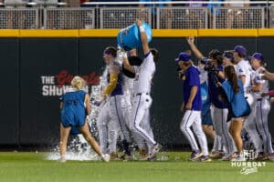LSU Tiger Jared Jones (22) celebrates the win, getting water dumped on him, over the against the Arkansas Razorbacks after single driving in Hernandez against the Arkansas Razorbacks during the College World Series on Wednesday, June 18, 2025 in Omaha, Nebraska. Photo by John S. Peterson.