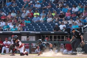 Coastal Carolina Chanticleer infielder Blake Barthol (7) slides home during a baseball game Thursday June 18th 2025 in Omaha Nebraska. Photo by Brandon Tiedemann.