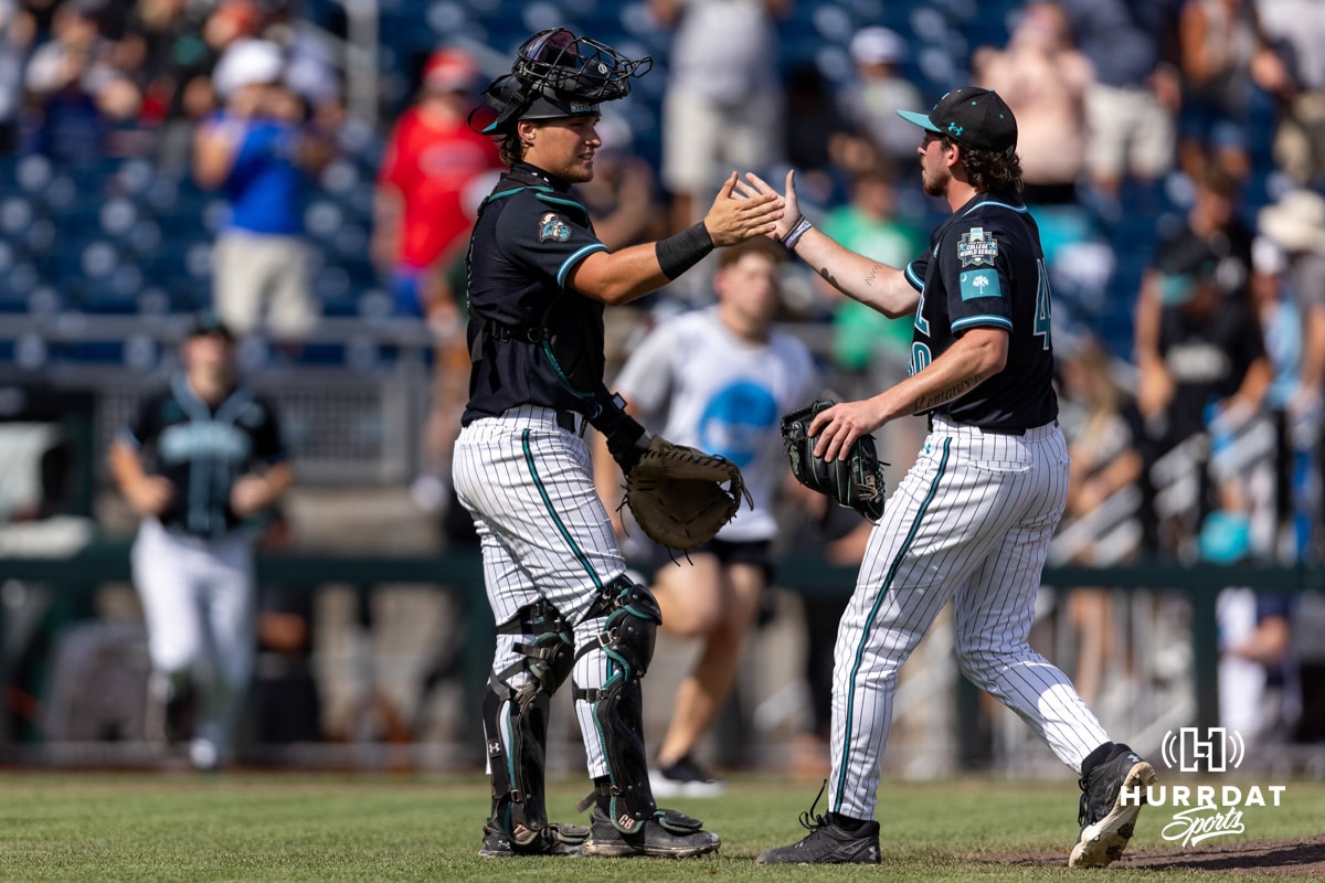 Coastal Carolina Chanticleer catcher Caden Bodine (17) gives the pitcher Dominick Carbone (40) five and a hug celebrating the win over the Louisville Cardinals during the College World Series on Wednesday, June 18, 2025 in Omaha, Nebraska. Photo by John S. Peterson.