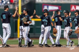 Coastal Carolina Chanticleers high five after the win over the Louisville Cardinals during the College World Series on Wednesday, June 18, 2025 in Omaha, Nebraska. Photo by John S. Peterson.