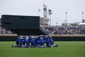The UCLA Bruins huddle before a game against Murray State on June 14th, 2025 in Omaha, Nebraska. Photo by John Peterson.
