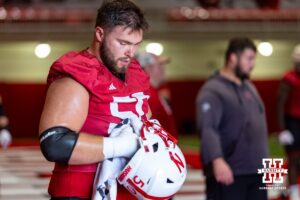 Nebraska Cornhusker Rocco Spindler (50) drying out his helmet during practice on Monday, July 28, 2025 in Lincoln, Nebraska. Photo by John S. Peterson.