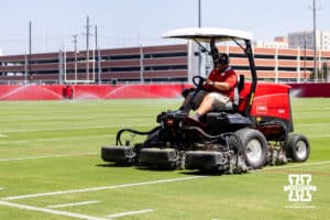 Nebraska grounds crew mowing the new grass on the practice field after practice on Monday, July 28, 2025 in Lincoln, Nebraska. Photo by John S. Peterson.