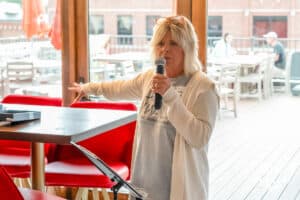 Jacque Tevis-Butler talks during the National Women’s Athletic Leadership Alliance Awards Monday July 21st 2025 in Omaha, Nebraska. Photo by Brandon Tiedemann.