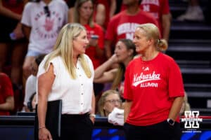 Nebraska Cornhuskers head coach Dani Busboom Kelly and the head coach for the alumni team Renee Saunders talk before the start of the Nebraska alumni match on Saturday, Aug. 16, 2025 in Lincoln, Nebraska. Photo by John S. Peterson.