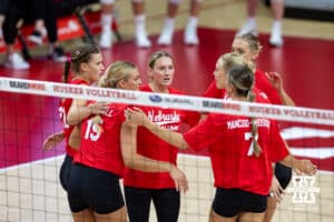 Nebraska alumni huddle up agains the Nebraska Cornhuskers during the Nebraska alumni match on Saturday, Aug. 16, 2025 in Lincoln, Nebraska. Photo by John S. Peterson.
