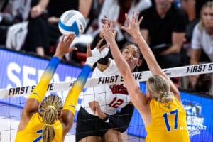 Nebraska Cornhuskers Taylor Landfair (12) spikes the ball against Pittsburgh Panthers Bre Kelley (21) and Brooke Mosher (17) in the first set during the AVAC Showcase volleyball match on Friday, August 22, 2025, in Lincoln, Nebraska. Photo by John S. Peterson.