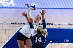 Creighton Bluejay Eloise Brandewie (10) spikes the ball against Penn State Nittany Lion Caroline Jurevicius (14) in the first set during the AVAC First Serve volleyball match on Saturday, Aug. 23, 2025 in Lincoln, Nebraska. Photo by John S. Peterson.