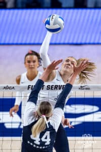 Creighton Bluejay Kiara Reinhardt (5) spikes the ball against Penn State Nittany Lion Maggie Mendelson (44) in the first set during the AVAC First Serve volleyball match on Saturday, Aug. 23, 2025 in Lincoln, Nebraska. Photo by John S. Peterson.