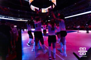 Nebraska Cornhuskers huddle up before the start of the match against the Stanford Cardinals during the AVAC First Serve volleyball match on Sunday, Aug. 24, 2025 in Lincoln, Nebraska. Photo by John S. Peterson.