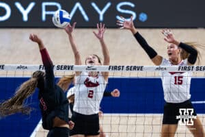 Nebraska Cornhusker Bergen Reilly (2) and Nebraska Cornhusker Andi Jackson (15) attempt to block a spike from Stanford Cardinal Jordyn Harvey (5) in the first set during the AVAC First Serve volleyball match on Sunday, Aug. 24, 2025 in Lincoln, Nebraska. Photo by John S. Peterson.