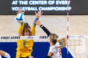 Nebraska Cornhusker Andi Jackson (15) spikes the ball against Pittsburgh Panther Blaire Bayless (8) during the AVAC Showcase volleyball match on Friday, Aug. 22, 2025, in Lincoln, Nebraska. Photo by John S. Peterson.