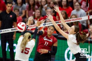 Nebraska Cornhusker Teraya Sigler (11) spikes the ball against Andi Jackson (15) and Bergen Reilly (2) during the Red/White Scrimmage on Saturday, Aug. 9, 2025 in Lincoln, Nebraska. Photo by John S. Peterson.