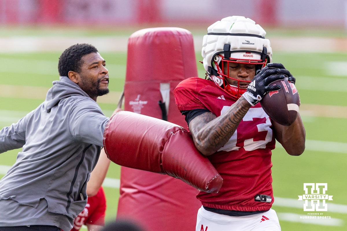 Nebraska Cornhusker Nyziah Hunter (13) makes a catch with coach Shorts challenging him during Nebraska’s football open scrimmage on Saturday, Aug. 2, 2025 in Lincoln, Nebraska. Photo by John S. Peterson.