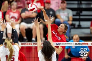 Nebraska alumnus Gina Mancuso-Prososki (7) spikes the ball against Nebraska Cornhusker Andi Jackson (15) and Virginia Adriano (9) in the first set during the Nebraska alumni match on Saturday, Aug. 16, 2025 in Lincoln, Nebraska. Photo by John S. Peterson.