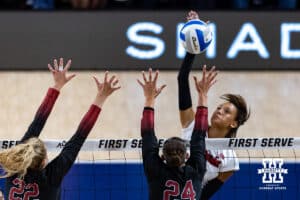 Nebraska Cornhusker Harper Murray (27) spikes the ball against Stanford Cardinal Logan Parks (24) and Erika Sayer (22) in the second set during the AVAC First Serve volleyball match on Sunday, Aug. 24, 2025 in Lincoln, Nebraska. Photo by John S. Peterson.