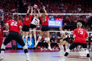 Nebraska Cornhusker Virginia Adriano (9) spikes the ball between Nebraska alumnus Anni (Albrecht) Moulder (17) and Callie Schwarzenbach (25) in the second set during the Nebraska alumni match on Saturday, Aug. 16, 2025 in Lincoln, Nebraska. Photo by John S. Peterson.