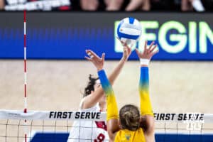 Nebraska Cornhusker Virginia Adriano (9) tips the ball over Pittsburgh Panther Blaire Bayless (8) in the second set during the AVAC Showcase volleyball match on Friday, Aug. 22, 2025, in Lincoln, Nebraska. Photo by John S. Peterson.