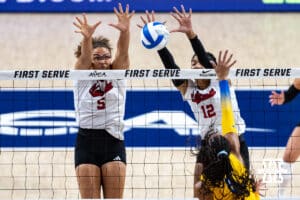 Nebraska Cornhuskers Rebekah Allick (5) and Taylor Landfair (12) jump up to block Pittsburgh Panther Olivia Babcock (5) in set two during the AVAC Showcase volleyball match on Friday, Aug. 22, 2025, in Lincoln, Nebraska. Photo by John S. Peterson.