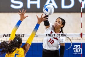 Nebraska Cornhusker Taylor Landfair (12) spikes the ball against Pittsburgh Panther Olivia Babcock (5) in the second set during the AVAC Showcase volleyball match on Friday, Aug. 22, 2025, in Lincoln, Nebraska. Photo by John S. Peterson.