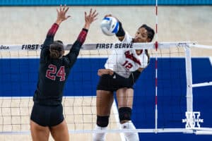 Nebraska Cornhusker Taylor Landfair (12) spikes the ball against Stanford Cardinal Logan Parks (24) in the second set during the AVAC First Serve volleyball match on Sunday, Aug. 24, 2025 in Lincoln, Nebraska. Photo by John S. Peterson.