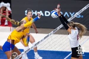 Nebraska Cornhusker Andi Jackson (15) blocks the ball against Pittsburgh Panther Bre Kelley (21) in the third set during the AVAC Showcase volleyball match on Friday, Aug. 22, 2025 in Lincoln, Nebraska. Photo by John S. Peterson.