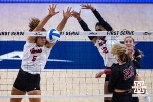 Nebraska Cornhusker Rebekah Allick (5) and Nebraska Cornhusker Taylor Landfair (12) blocks a spike from Stanford Cardinal Erika Sayer (22) in the second set during the AVAC First Serve volleyball match on Sunday, Aug. 24, 2025 in Lincoln, Nebraska. Photo by John S. Peterson.