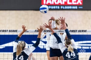 Creighton Bluejay Eloise Brandewie (10) spikes the ball against Penn State Nittany Lion Caroline Jurevicius (14) and Maggie Mendelson (44) in the second set during the AVAC First Serve volleyball match on Saturday, Aug. 23, 2025 in Lincoln, Nebraska. Photo by John S. Peterson.