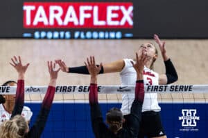 Nebraska Cornhusker Allie Sczech (3) prepares to spike the ball against Stanford Cardinal Logan Parks (24) and Erika Sayer (22) in the second set during the AVAC First Serve volleyball match on Sunday, Aug. 24, 2025 in Lincoln, Nebraska. Photo by John S. Peterson.