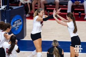 Nebraska Cornhusker Allie Sczech (3) and Nebraska Cornhusker Bergen Reilly (2) give each other high fives in the second set during the AVAC First Serve volleyball match on Sunday, Aug. 24, 2025 in Lincoln, Nebraska. Photo by John S. Peterson.