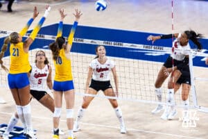 Nebraska Cornhusker Harper Murray (27) spikes the ball against Pittsburgh Panthers Bre Kelley (21) and Marina Pezelj (10) in the fourth set during the AVAC Showcase volleyball match on Friday, Aug. 22, 2025, in Lincoln, Nebraska. Photo by John S. Peterson.