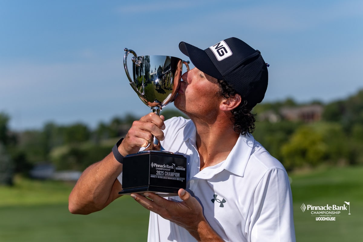 Christo Lamprecht kisses the trophy for photos after his win during the Pinnacle Bank Championship on Sunday, Aug. 10, 2025, in Elkhorn, Nebraska. Photo by John S. Peterson.