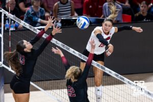 Nebraska Cornhusker Andi Jackson (15) spikes the ball against Stanford Cardinal Elia Rubin (13) and Erika Sayer (22) in the third set during the AVAC First Serve volleyball match on Sunday, Aug. 24, 2025 in Lincoln, Nebraska. Photo by John S. Peterson.