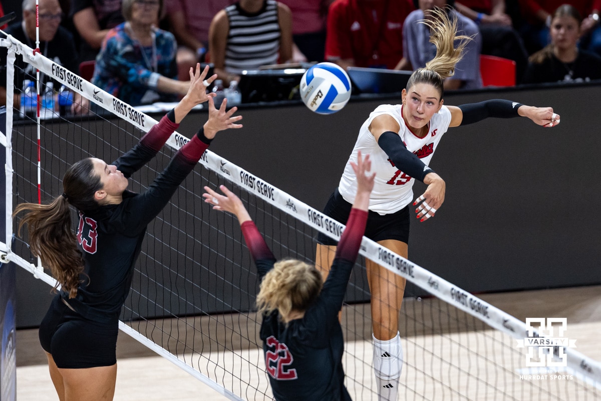 Nebraska Cornhusker Andi Jackson (15) spikes the ball against Stanford Cardinal Elia Rubin (13) and Erika Sayer (22) in the third set during the AVAC First Serve volleyball match on Sunday, Aug. 24, 2025 in Lincoln, Nebraska. Photo by John S. Peterson.