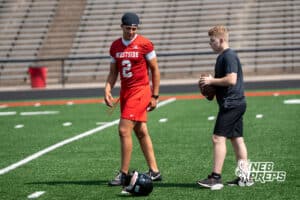 Braylen Warren teaches a manager how to drop back during Westside football practice on Tuesday, August 12th, 2025 in Omaha Nebraska. Photo by Brandon Tiedemann.