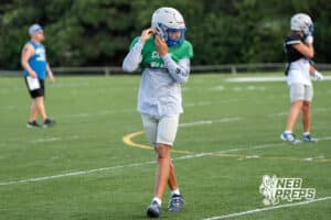 Christin Bolles adjusts his helmet during Millard North football practice on Saturday, August 16th, 2025 in Omaha, Nebraska. Photo by Brandon Tiedemann.
