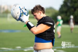 Nate Maraable puts on his helmet during Millard North football practice on Saturday, August 16th, 2025 in Omaha, Nebraska. Photo by Brandon Tiedemann.