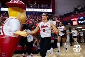 Nebraska Cornhusker Rebekah Allick (5) gives Lil' Red five on the way out to the court before taking on the Grand Canyon Lopes during a college volleyball match on Saturday, September 13, 2025, in Lincoln, Nebraska. Photo by John S. Peterson.