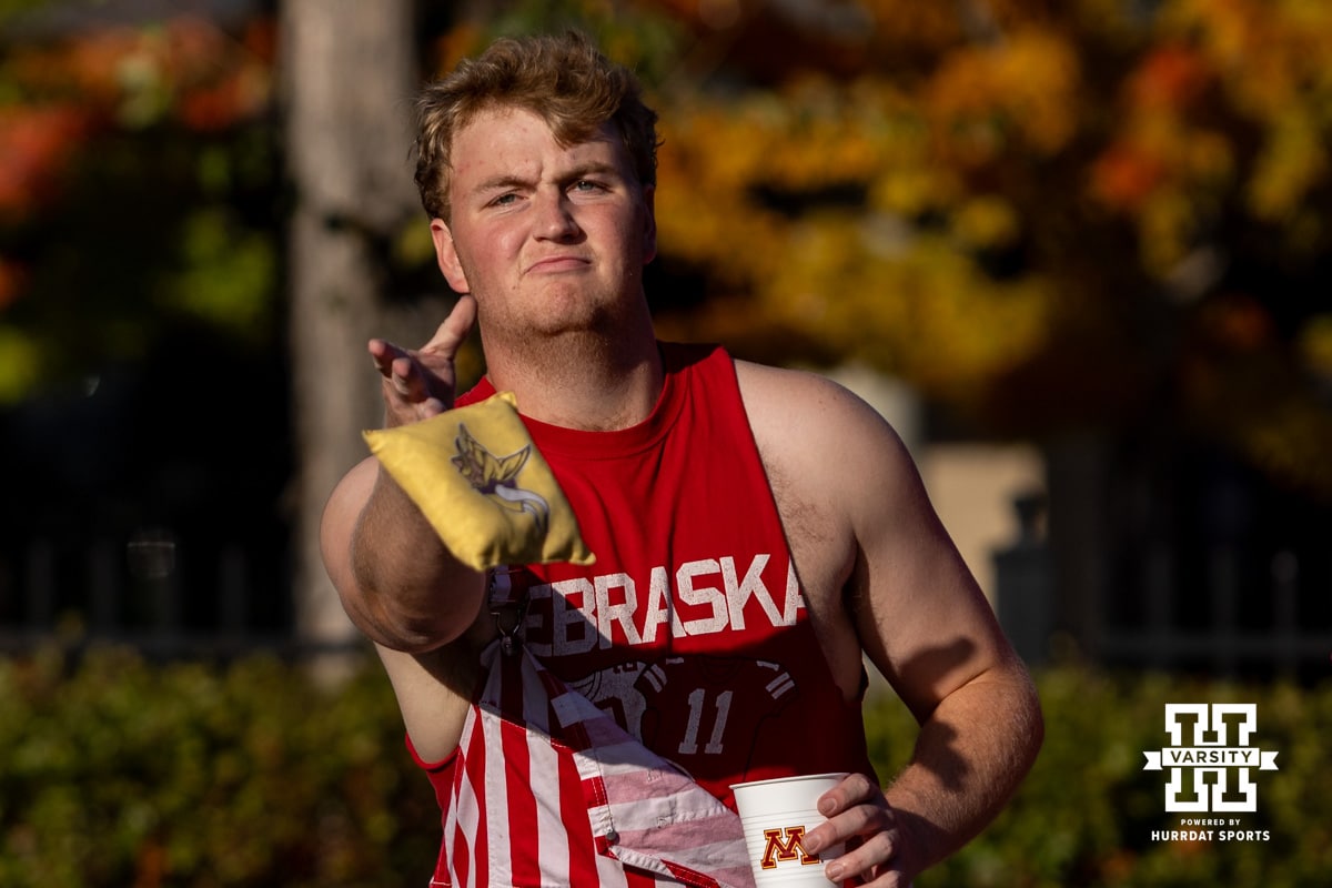 Nebraska Cornhusker fan playing cornhole tailgating before the Huskers take on Minnesota during a college football game on Friday, October 17, 2025, in Minneapolis, Minnesota. Photo by John S. Peterson.